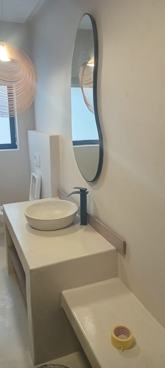 Project photo showing a seamless wall and built-in counter finish in a bathroom