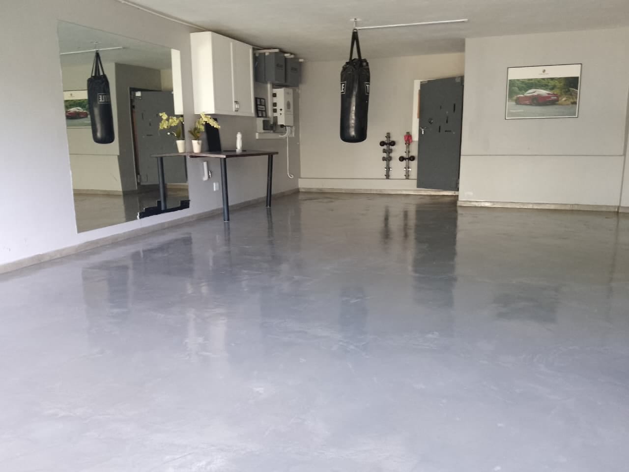 Project photo showing a finished floor in a fitted home gym and studio space