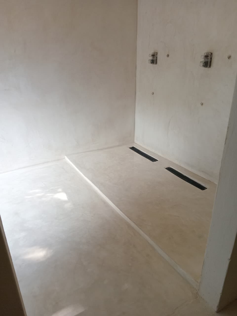 Site photo showing wall and floor coatings laid before the fixtures are fitted