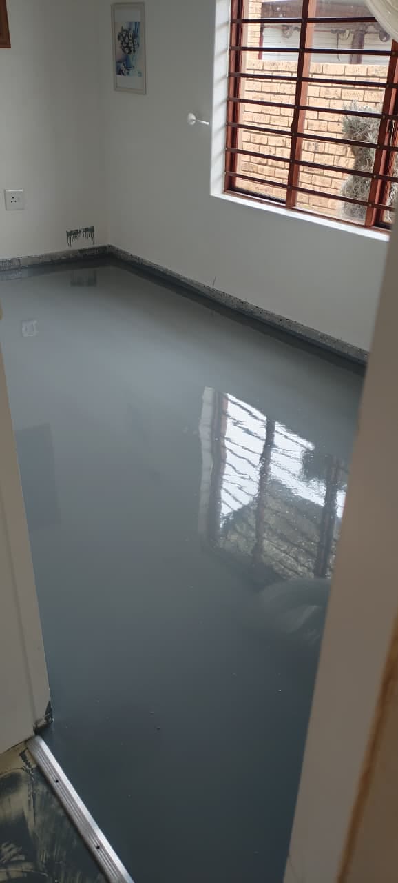 Site photo showing a fresh floor coating before the trim and edges are finished