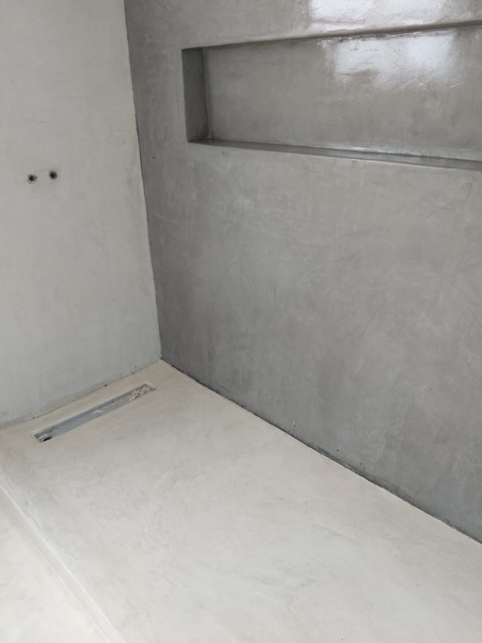 Project photo showing a grey wall finish with a recessed niche