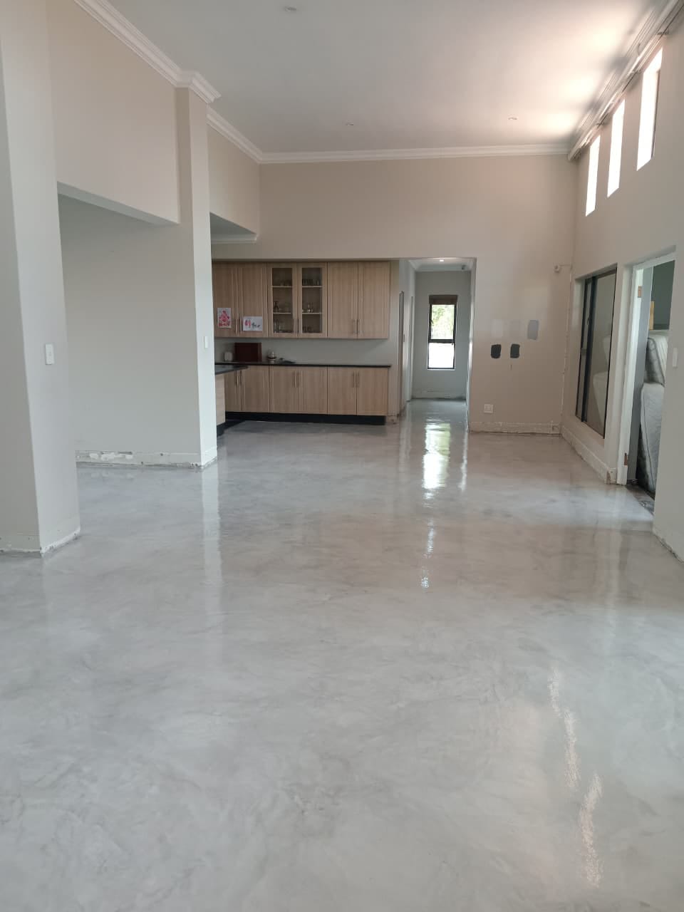 Project photo showing a glossy finished floor in a room still being finished